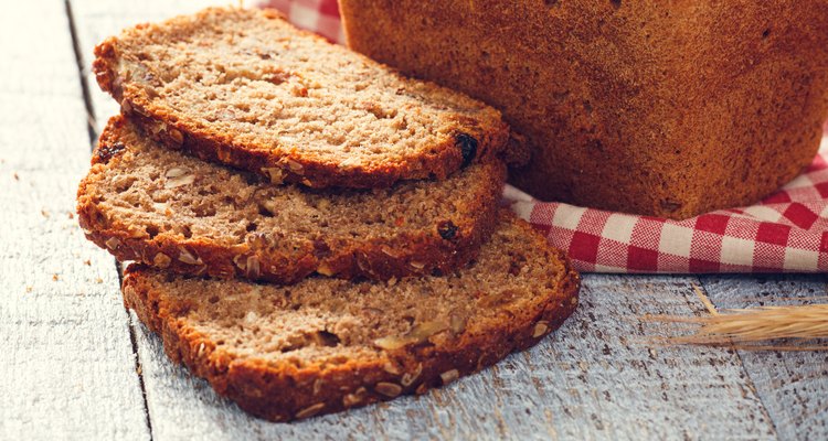 Homemade bread with spikelet of wheat on cloth on boards