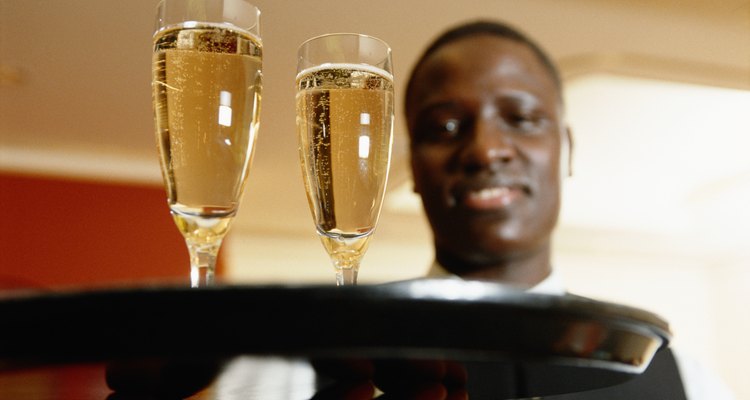 Waiter holding tray of champagne, focus on champagne flutes