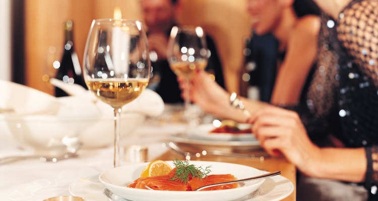 Close-up of dinner setting with salmon and wine