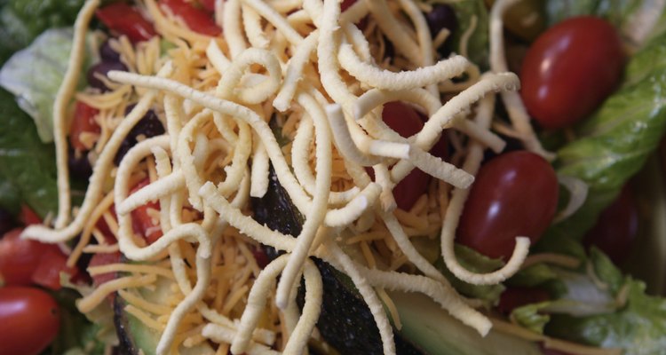 Salad with avocado slices and dried noodles