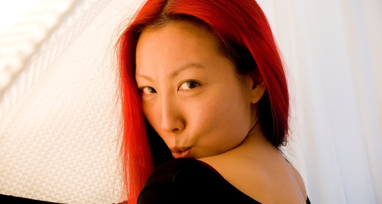 Asian woman with dyed red hair