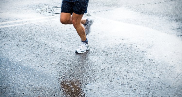 Marathon runner in rain on city street