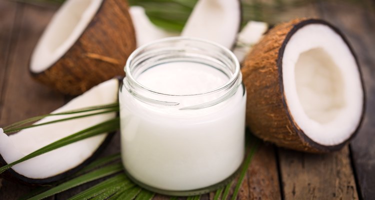 A jar of coconut oil on a wooden table