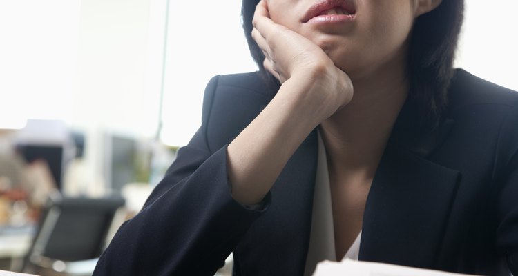 Young businesswoman sitting at desk bored