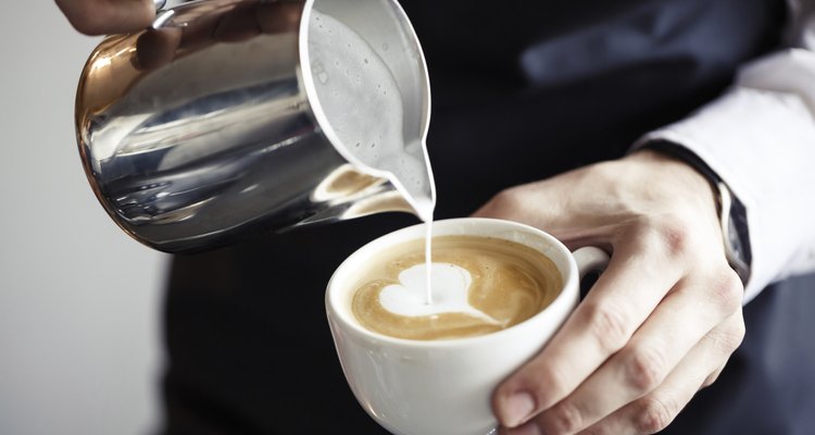 Barman making coffee, pouring milk