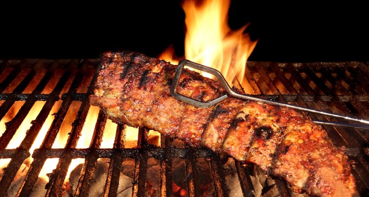 BBQ Roast Baby Back Pork Ribs Close-up On Hot  Grill