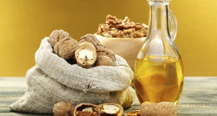 Walnut oil in bottle and nuts.