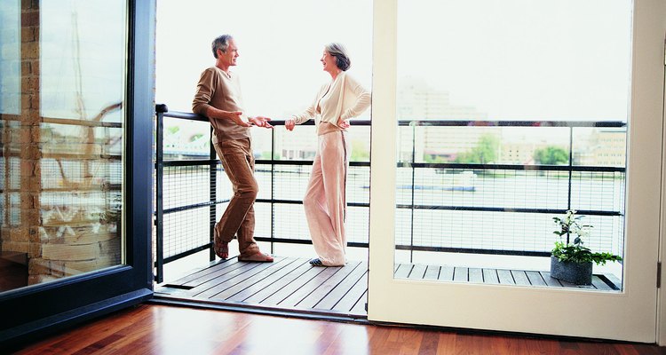 Mature Couple Talking on the Balcony of Their Apartment