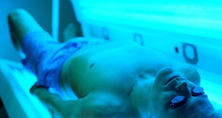 high angle view of a man lying in a tanning machine