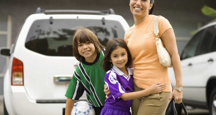 Mother with children (6-10) dressed in soccer uniforms