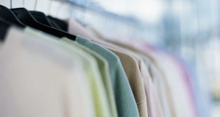 clothes hanging on a rack in a clothing store