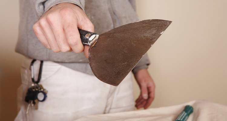Smooth joint compound over your uneven layers with a putty knife.