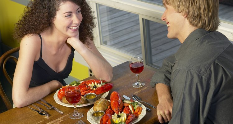 High angle view of a couple sitting in a restaurant eating seafood