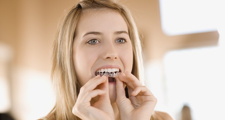 Teenage girl whitening teeth