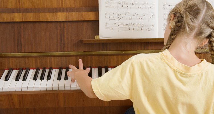 You can make an upright piano model out of a cardboard box and some black construction paper.