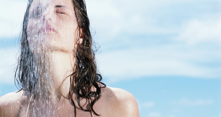 Woman under shower, outdoors