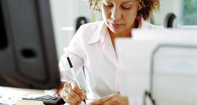 Mature woman doing finances in home office