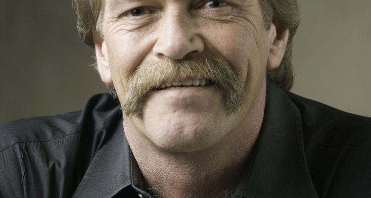 Man with moustache posing in studio, portrait