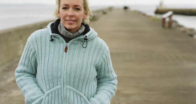 Mature woman outdoors by sea, smiling, portrait