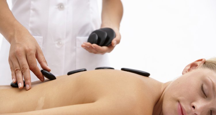 Young woman on treatment table receiving lastone therapy