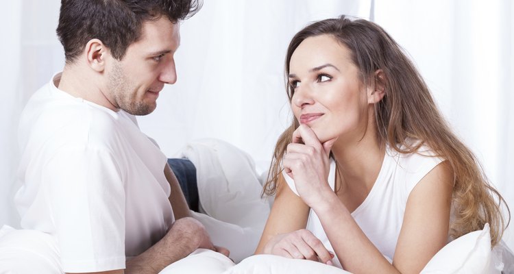 Couple contemplating in bed