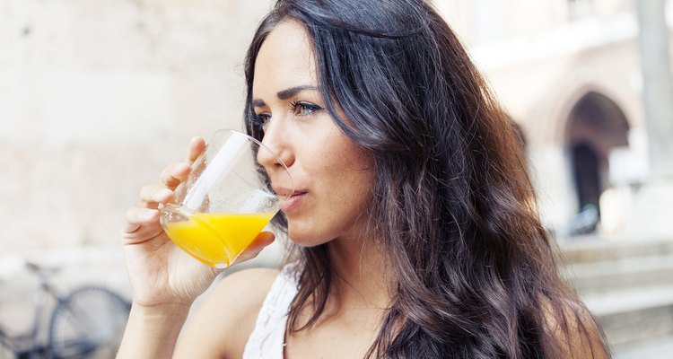 portrait of attractive girl while drinking an orange juice