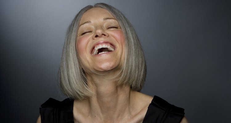 Mature woman laughing, eyes closed, close-up