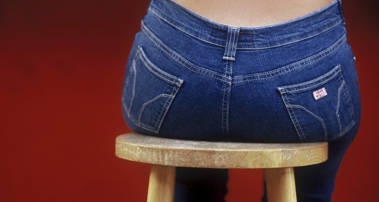 Woman's rear end sitting on barstool in jeans, Curacao