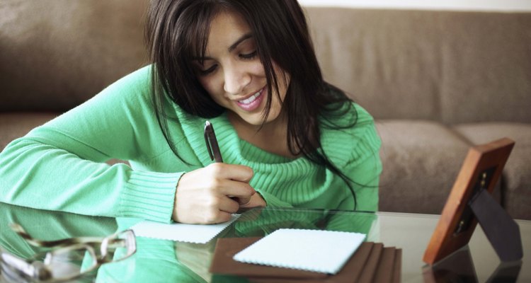 Woman writing note on coffee table