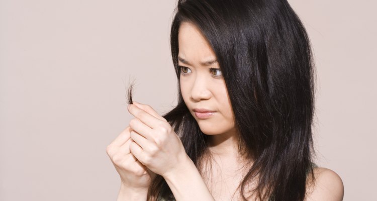 Woman inspecting split-ends