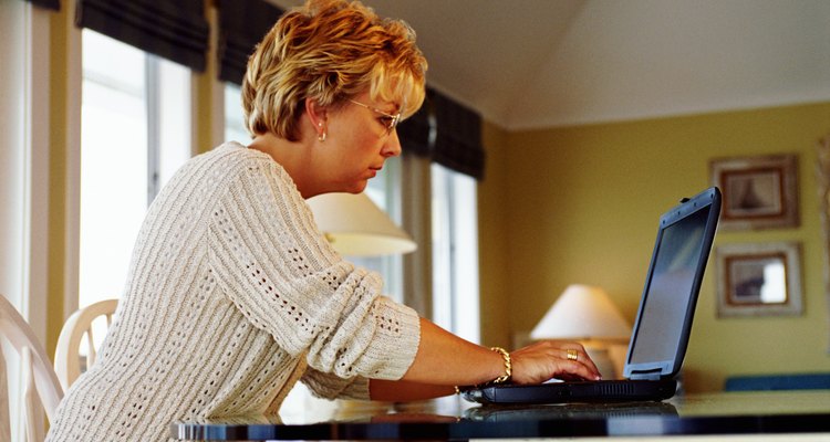 Woman using laptop at home