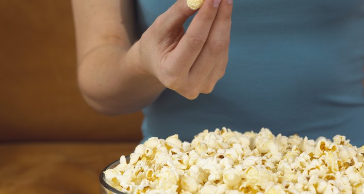 Taking popcorn from bowl