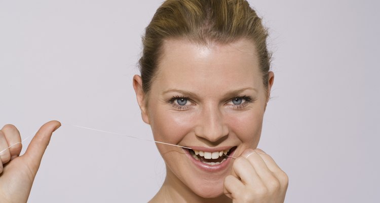 Woman using floss