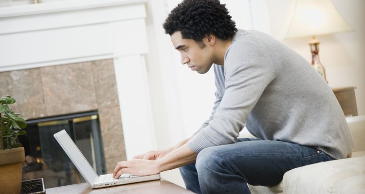 African man typing on laptop