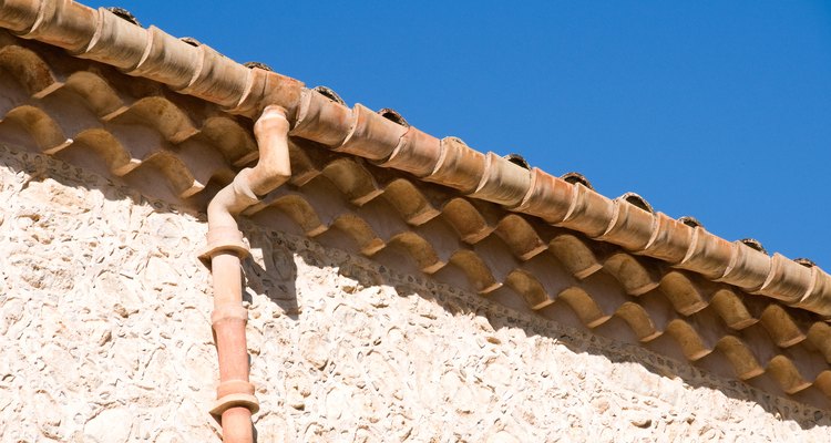 A gutter carries rainwater away from a house and into underground drainage.