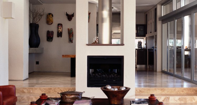 Building a double-sided fireplace in the centre of a room allows the fire to warm both sides of the space.