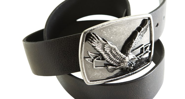 Leather belt with eagle on buckle on white background