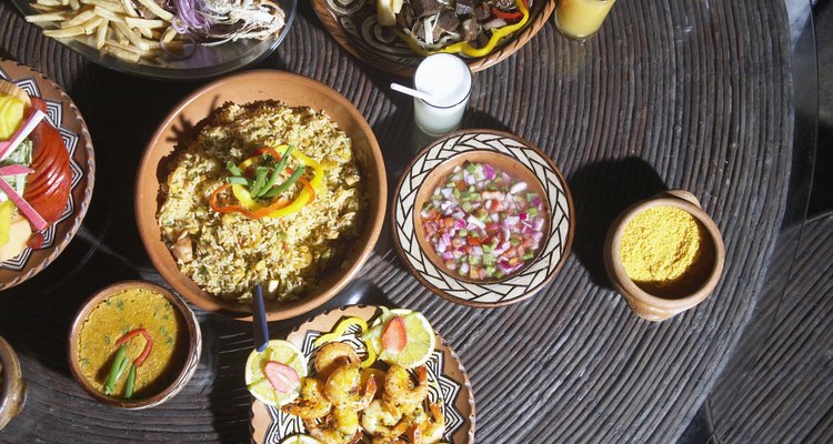 Platters of grilled fish, fried yucca, salad and fresh fruit