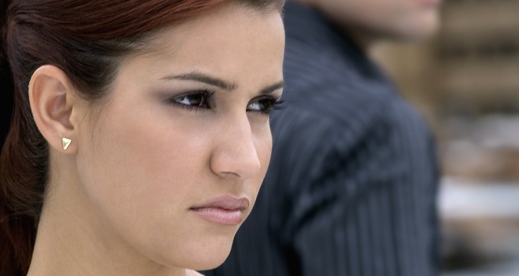 Front view of woman, back view of man, focus on woman, close-up