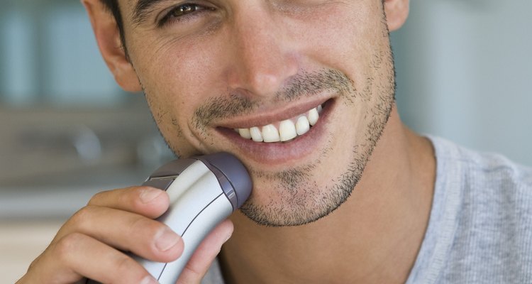 Man using electric shaver