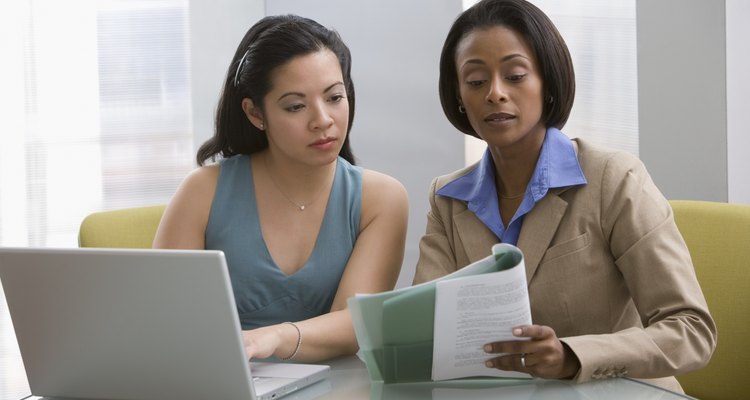 Multi-ethnic businesswomen discussing paperwork