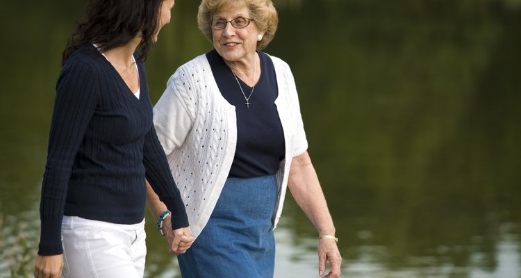 Two women walking beside a lake