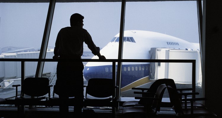 Man waiting at airport gazing out window