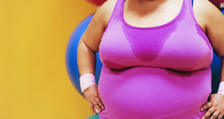 Smiling, Overweight Woman Standing in the Gym With Her Hands on Her Hips