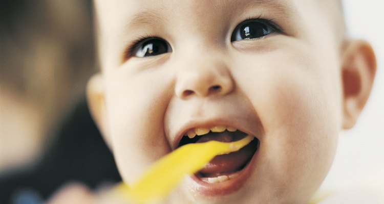 Headshot of a Baby Being Spoon Fed by its Parent