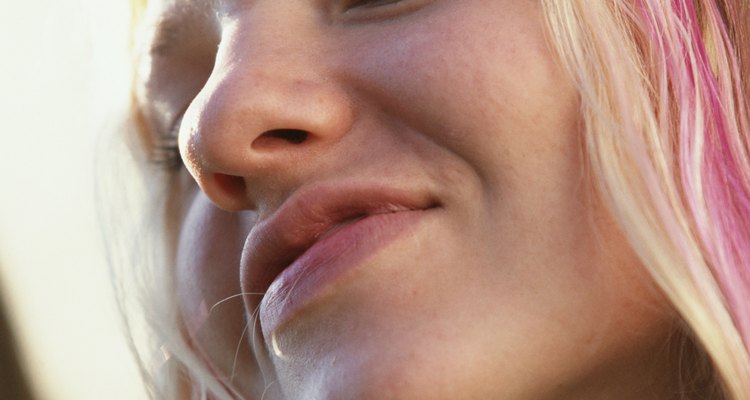 the headshot of a young teenage girl with blond and pink hair who is smiling confidntly at the camera