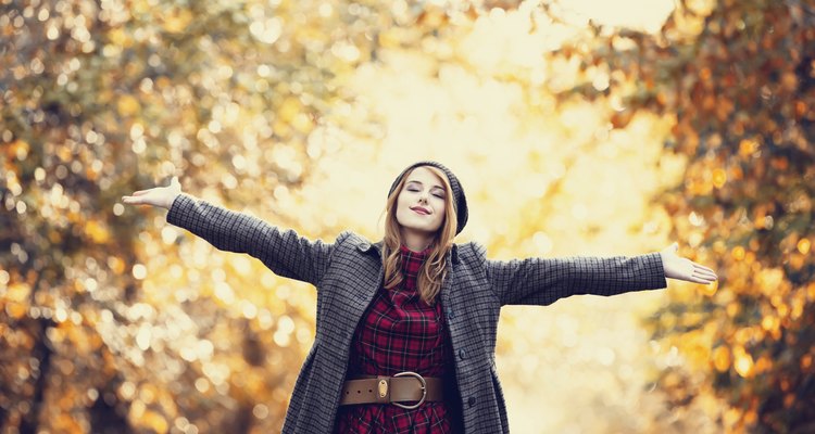 Style redhead girl at beautiful autumn alley.