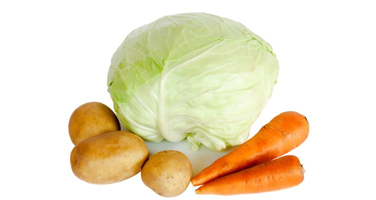 Fresh vegetables cabbage, potatoes and carrots isolated on white