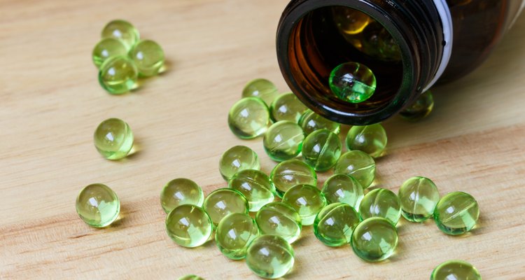 Supplement food,Vitamin E capsule on wooden table.