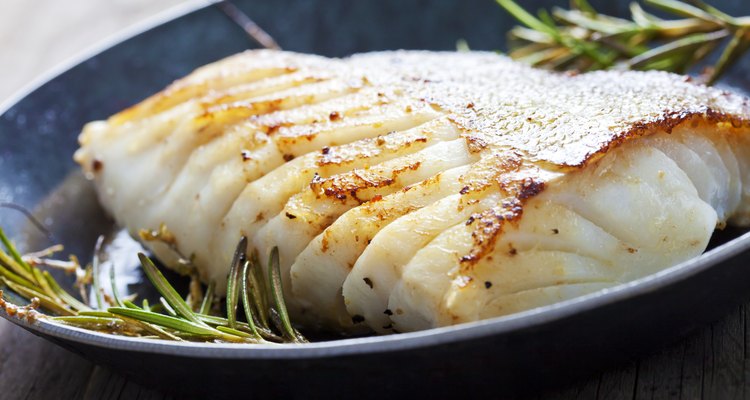 Fried fish fillet, Atlantic cod with rosemary in pan